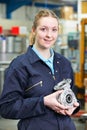Portrait Of Female Apprentice Holding Component Royalty Free Stock Photo
