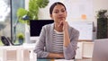 Portrait Of Female Architect In Office Sitting At Desk With Model Of New Building Royalty Free Stock Photo