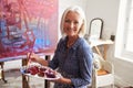 Portrait Of Female Artist Working On Painting In Studio Royalty Free Stock Photo