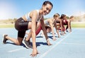 Portrait of female athlete motivated and ready to compete in track and field olympic event. Diverse group of competitive