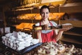 Portrait of female baker holding a tray of sweet foods