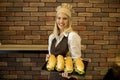 Female baker posing with various types of sandwiches in the baker shop Royalty Free Stock Photo