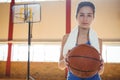 Portrait of female basketball player holding ball Royalty Free Stock Photo