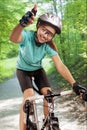 Portrait of female bike rider outside and showing thumbsup. comp Royalty Free Stock Photo