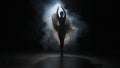 Portrait of female on black background under spotlight projector in studio. Ballerina in white tulle dancing slow Royalty Free Stock Photo