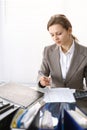 Portrait of female bookkeeper or financial inspector making report, calculating or checking balance. Copy space area