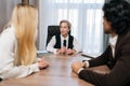 Portrait of female boss listening of businesswoman sharing opinion, presenting business idea, make speech during formal Royalty Free Stock Photo