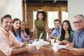 Portrait Of Female Boss With Team In Meeting