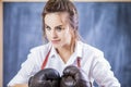 Portrait of Female Boxer Posing in Brown Leather Boxer Gloves Against Blackboard. Royalty Free Stock Photo