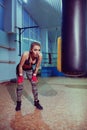 Portrait of female boxer in sport wear with fighting stance against spotlight. fitness blonde girl in sport wear Royalty Free Stock Photo