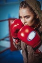 Portrait of female boxer in sport wear with fighting stance against spotlight. fitness blonde girl in sport wear Royalty Free Stock Photo