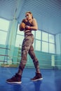 Portrait of female boxer in sport wear with fighting stance against spotlight. Sport, fitness concept. fitness blonde girl Royalty Free Stock Photo