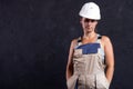Portrait of female builder in helmet and uniform in studio Royalty Free Stock Photo