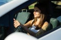 Portrait of female caucasian driver in car