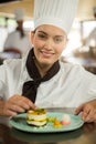 Portrait of female chef finishing dessert plates Royalty Free Stock Photo