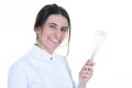 Portrait of female chef with pastry whip on white background