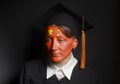 Portrait of Female chinese bachelor with painted China flag in Black mantle and Graduation Cap Royalty Free Stock Photo