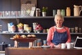 Portrait Of Female Coffee Shop Owner Standing Behind Counter Royalty Free Stock Photo