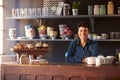 Portrait Of Female Coffee Shop Owner Standing Behind Counter Royalty Free Stock Photo