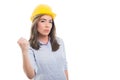 Portrait of female constructor showing fist looking mad