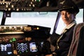 Portrait of female copilot sitting in captain cabin to fly plane