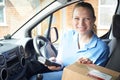 Portrait Of Female Courier In Van Delivering Package To Domestic Royalty Free Stock Photo