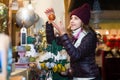 Portrait of female customer near counter with Christmas gifts