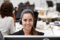 Portrait Of Female Customer Services Agent Working At Desk In Call Center Royalty Free Stock Photo