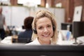 Portrait Of Female Customer Services Agent Working At Desk In Call Center Royalty Free Stock Photo