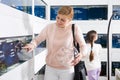 Portrait of female customer visiting pet store in search of aquarium fish Royalty Free Stock Photo