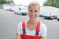 portrait female delivery driver wearing red dungarees Royalty Free Stock Photo