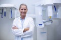 Portrait of female dentist smiling with arms crossed Royalty Free Stock Photo