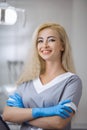 Portrait of female dentist smiling with arms crossed in dental clinic Royalty Free Stock Photo