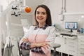 Portrait of female dentist smiling with arms crossed in dental clinic Royalty Free Stock Photo