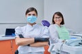 Portrait of female dentist with woman patient sitting in dental chair Royalty Free Stock Photo