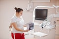 Portrait of female dentist woman standing in her dentistry office looking on x-ray photos Royalty Free Stock Photo