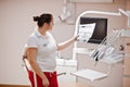 Portrait of female dentist woman standing in her dentistry office looking on x-ray photos Royalty Free Stock Photo