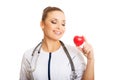 Portrait of female doctor holding heart model