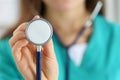 Portrait of female doctor holding stethoscope head