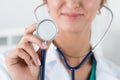 Portrait of female doctor holding stethoscope head