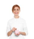 Portrait of female doctor with piggy bank Royalty Free Stock Photo