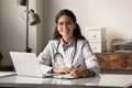 Portrait of female doctor sit at desk in hospital Royalty Free Stock Photo