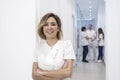 Portrait of female doctor standing with arms crossed in corridor Royalty Free Stock Photo