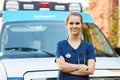 Portrait Of Female Doctor Standing In Front Of Ambulance