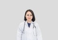 Portrait female doctor standing on white background in uniform wear glasses and stethoscope, copy space. medical-care concept Royalty Free Stock Photo