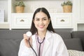 Portrait of Female doctor with stethoscope at office and smiling at camera Royalty Free Stock Photo