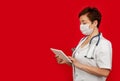 Portrait of a female doctor using her digital tablet. Female doctor using tablet and checking with analysis