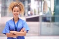 Portrait Of Female Doctor Wearing Scrubs Standing In Modern Hospital Building Royalty Free Stock Photo