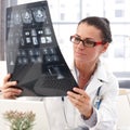 Portrait of female doctor with x-ray image in hand Royalty Free Stock Photo