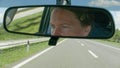 Portrait of female driver in car rear view mirror Royalty Free Stock Photo